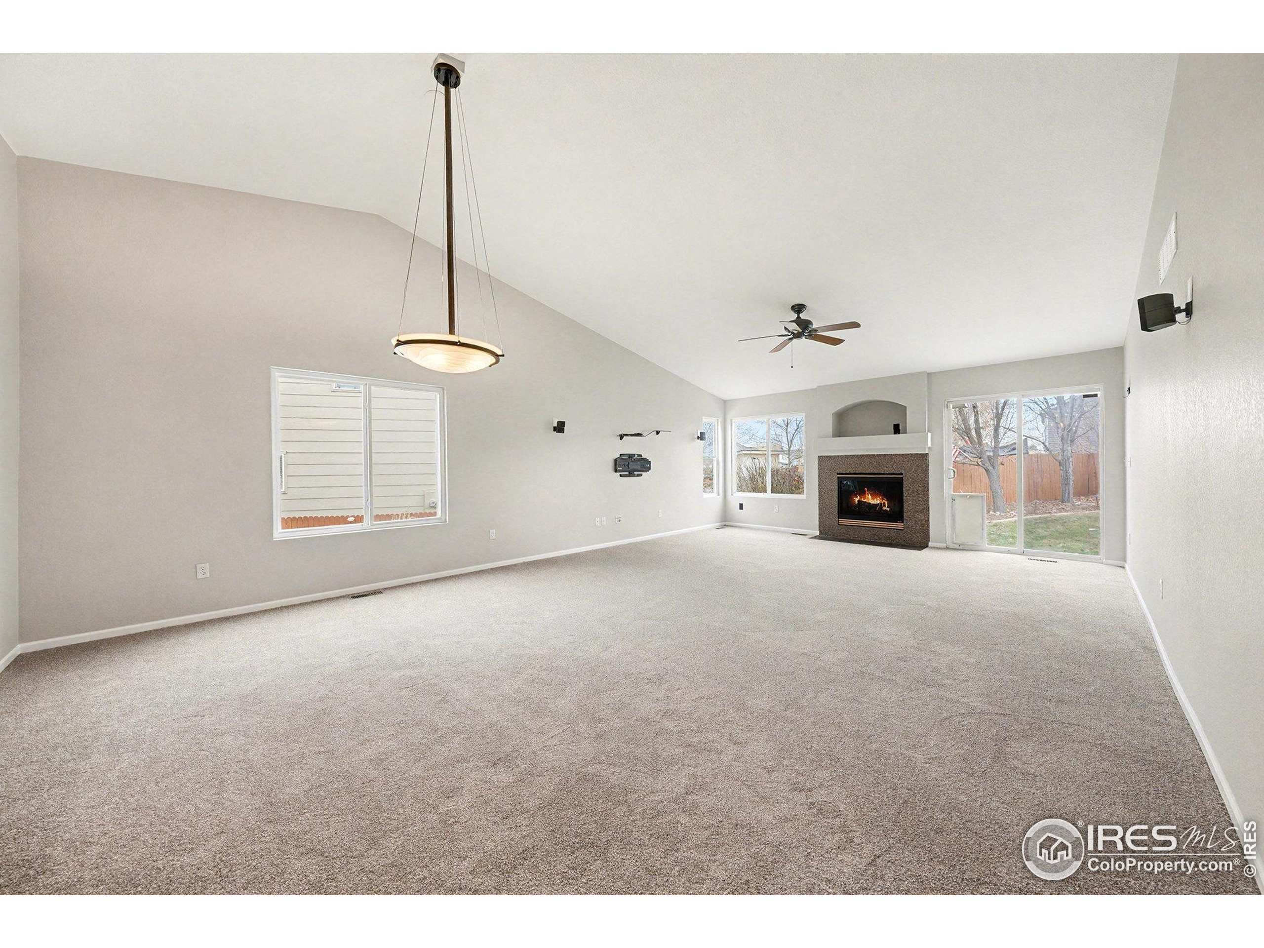 5740 High Street Frederick, CO 80504 - Photo 3 of 34 a view of empty room with fireplace and fan