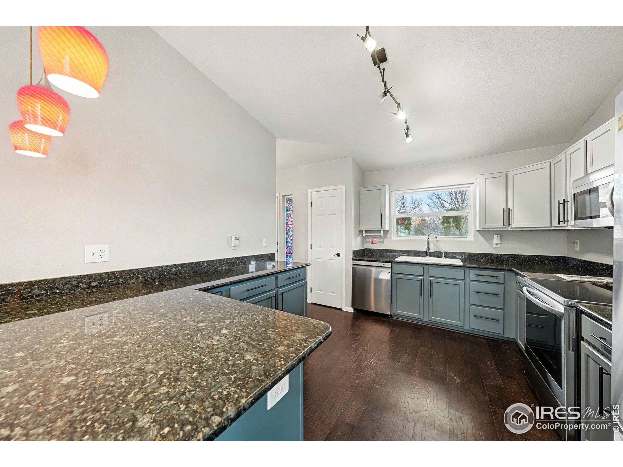 5740 High Street Frederick, CO 80504 - Photo 6 of 34 a kitchen with a stove a sink and a refrigerator