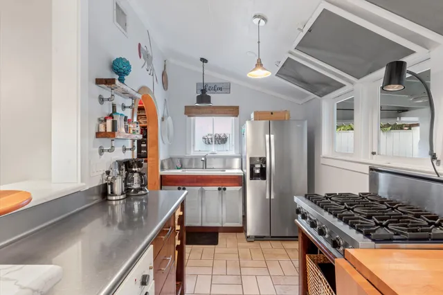 a kitchen with a stove a sink and a dining table