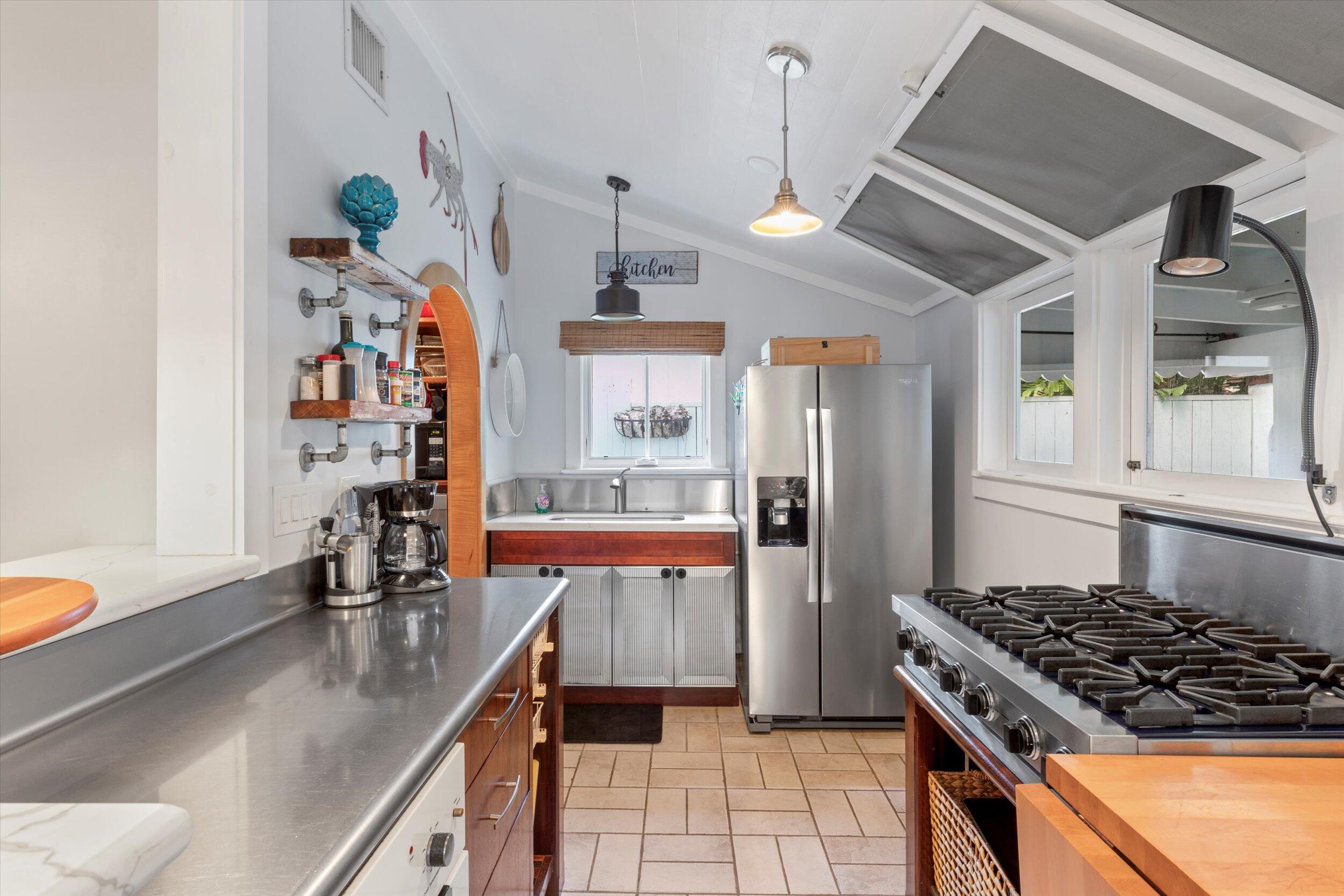 626 Margaret Street Key West, FL 33040 - Photo 19 of 45 a kitchen with stainless steel appliances granite countertop a sink stove and refrigerator