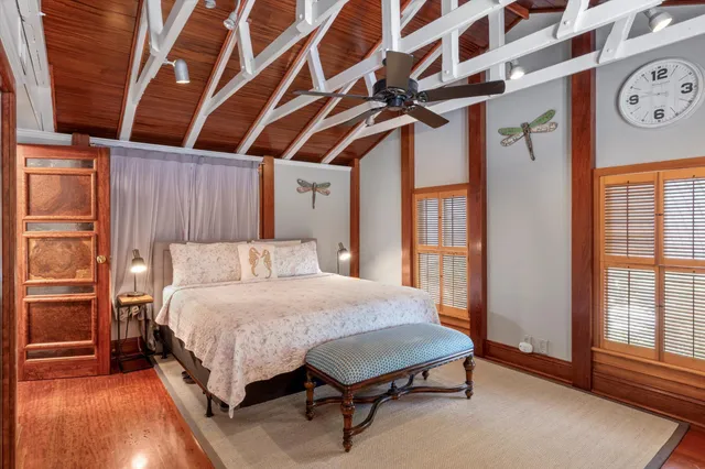 a bedroom with a bed and a chandelier