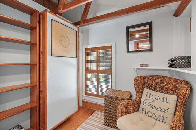 a view of a livingroom with furniture and a window