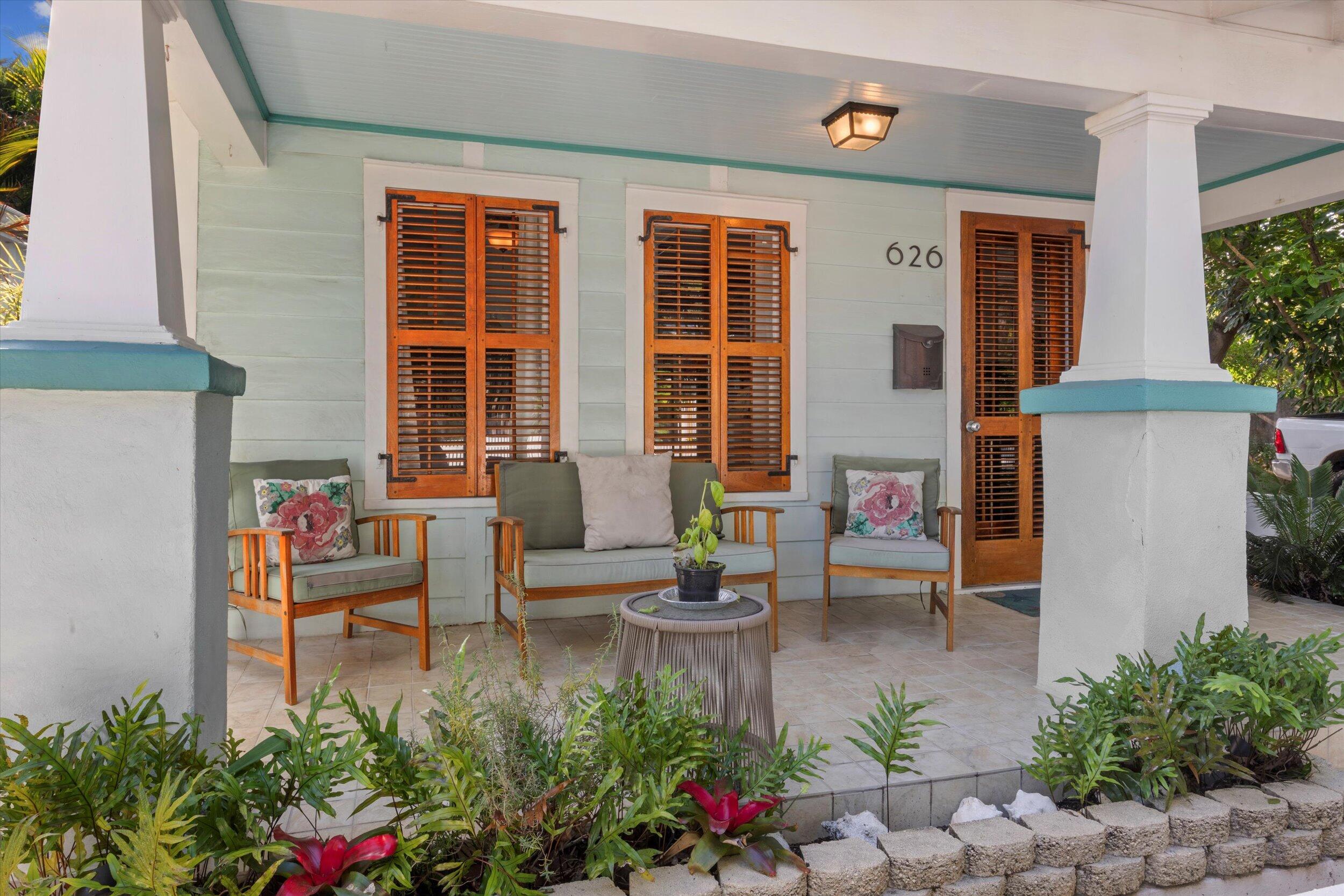 626 Margaret Street Key West, FL 33040 - Photo 4 of 45 a view of a patio with couches table and chairs and potted plants
