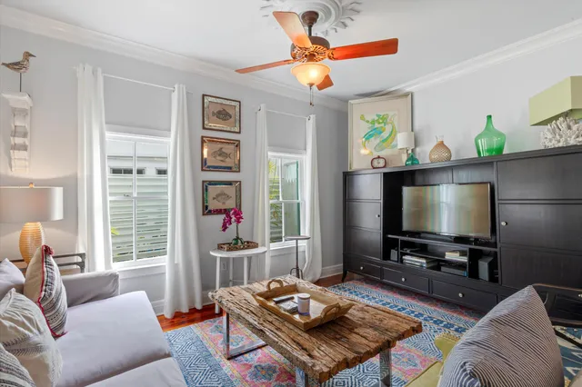 a living room with furniture a flat screen tv and a fireplace