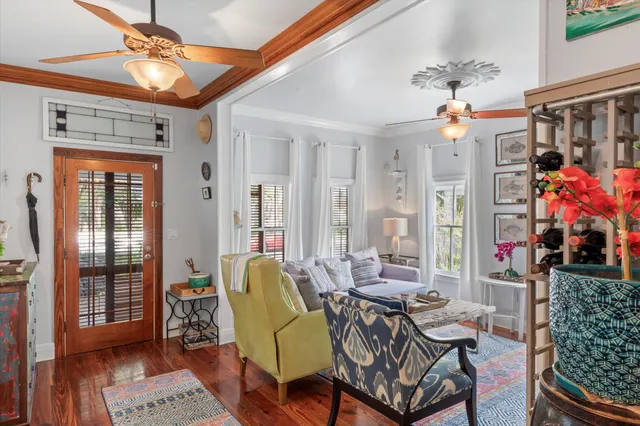 a living room with furniture and wooden floor