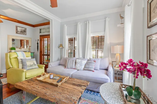 a living room with furniture a chandelier and a window