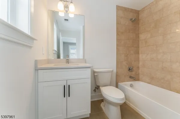 a bathroom with a toilet and a bathtub