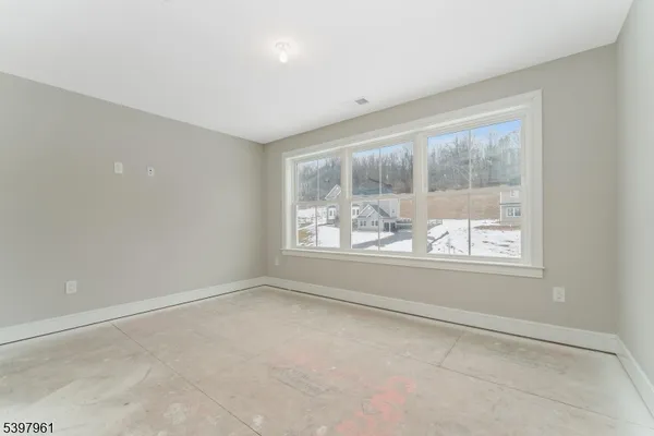 a view of a hallway with wooden floor and entryway