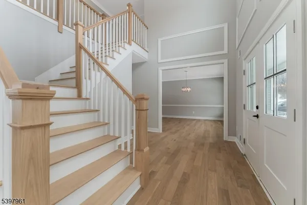 a view of entryway with wooden floor and stairs