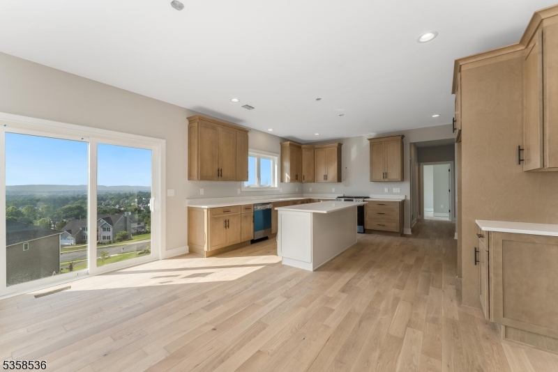 4 Spring Court Phillipsburg, NJ 08865 - Photo 3 of 30 a large white kitchen with a refrigerator a sink dishwasher a stove and a large countertops with wooden floor