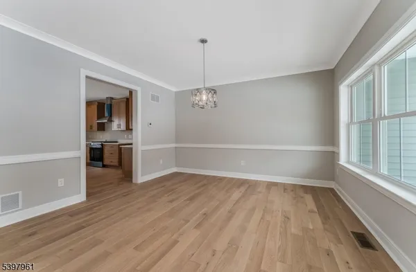 wooden floor fireplace and windows in an empty room