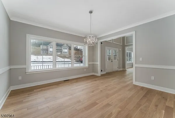 a view of empty room with wooden floor and fireplace