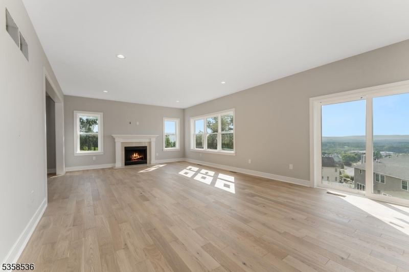 4 Spring Court Phillipsburg, NJ 08865 - Photo 8 of 30 an empty room with wooden floor and fireplace