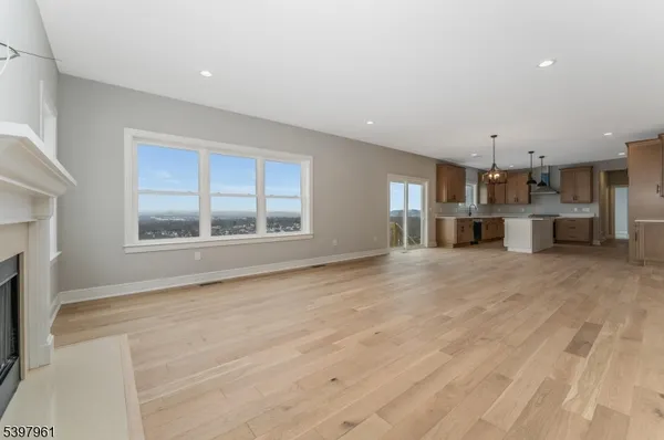 a view of a kitchen with stainless steel appliances granite countertop a sink and cabinets