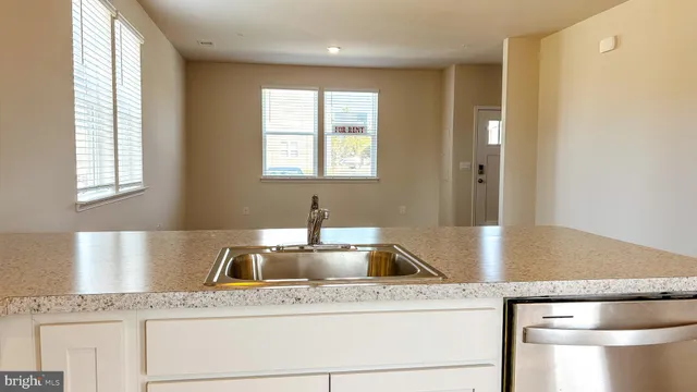 a kitchen with a sink cabinets and window