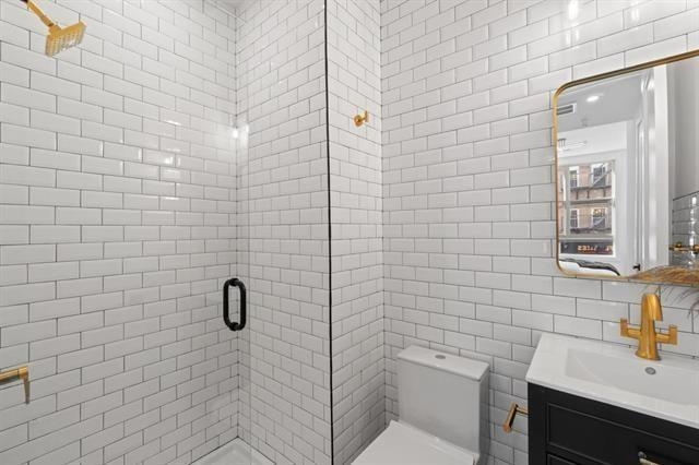 491 Broadway, Unit 202 Bayonne, NJ 07002 - Photo 13 of 20 a bathroom with a sink a toilet and shower