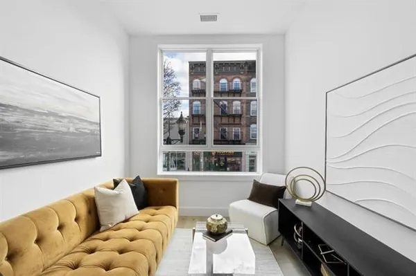 a living room with furniture and floor to ceiling window