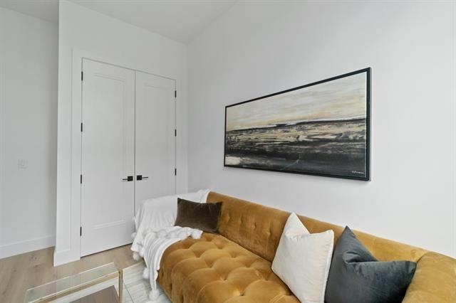 491 Broadway, Unit 202 Bayonne, NJ 07002 - Photo 15 of 20 a living room with furniture and a painting on the wall