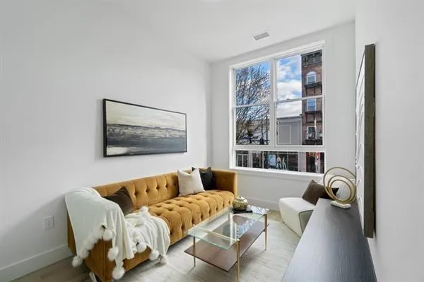 a living room with furniture and a large window