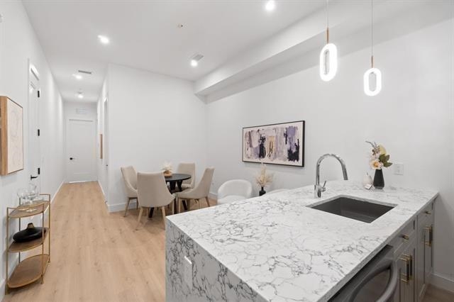 491 Broadway, Unit 202 Bayonne, NJ 07002 - Photo 2 of 20 a kitchen with a sink a table and chairs
