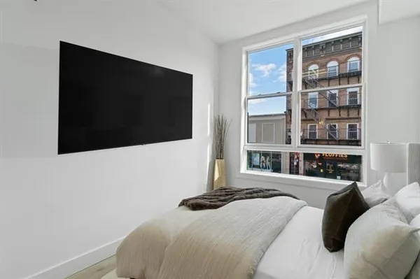 a bedroom with a bed and a flat screen tv