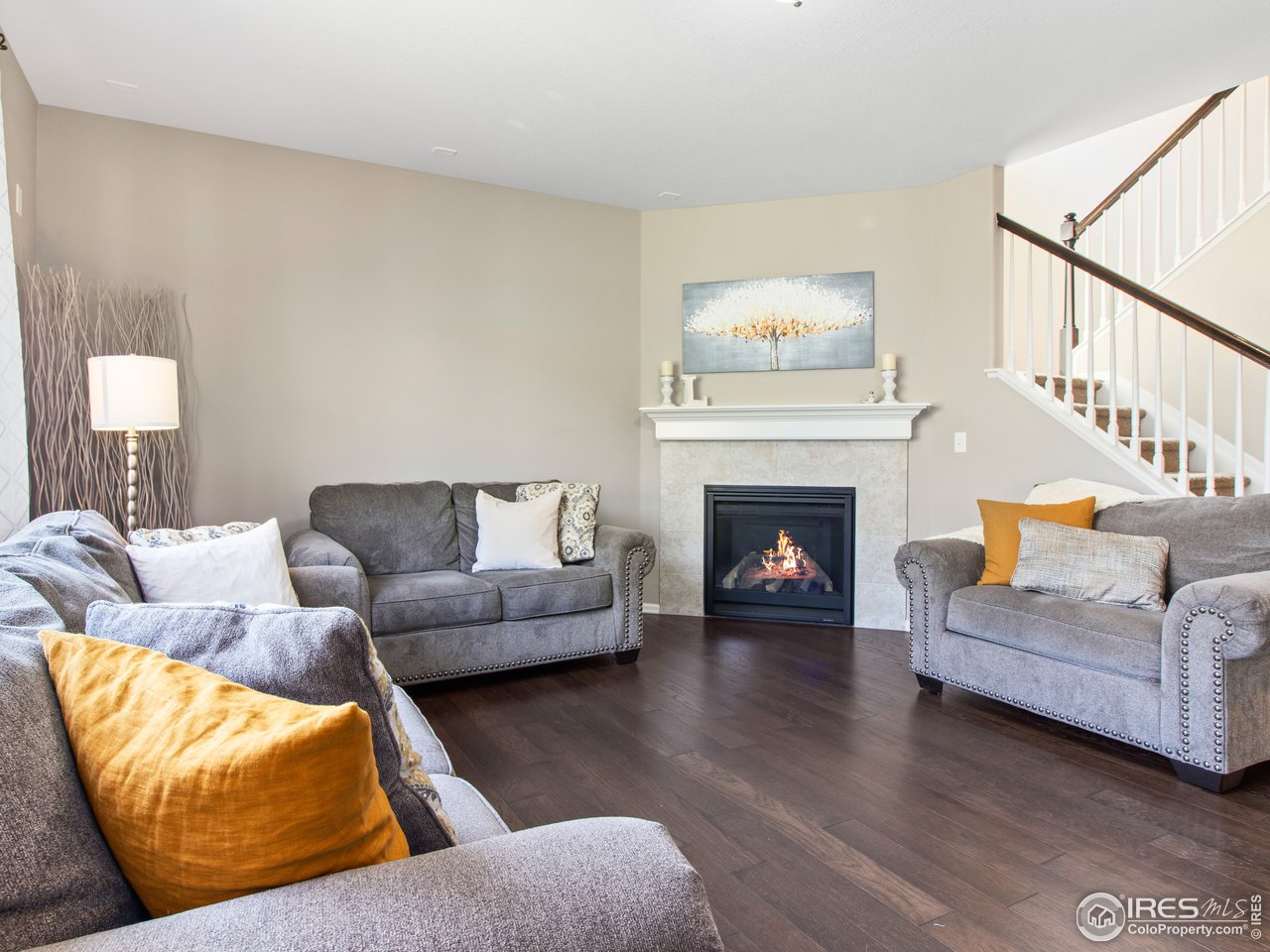 3318 Quicksilver Road Frederick, CO 80516 - Photo 12 of 28 Great room with a cozy fireplace and wood flooring throughout