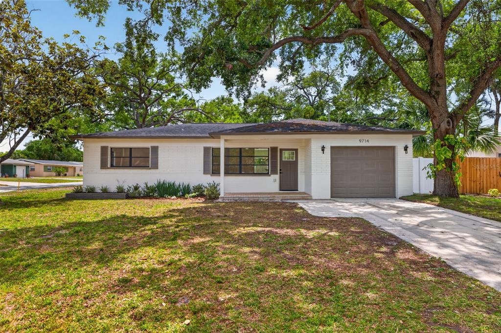 9714 53rd Avenue North St. Petersburg, FL 33708 - Photo 1 of 1 a view of a house with a yard and large tree