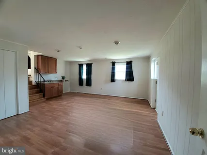 a view of a livingroom with furniture and a window