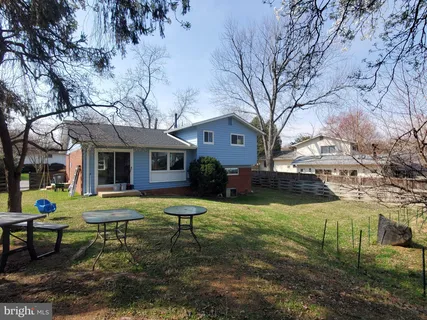 a view of a house with backyard sitting area and garden