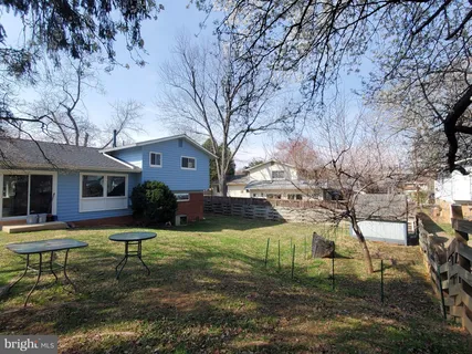 a backyard of a house with table and chairs