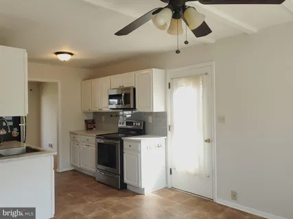 a kitchen with a sink stainless steel appliances and cabinets