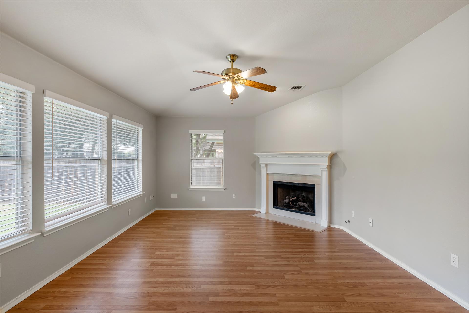 4725 Tello Path Austin, TX 78749 - Photo 14 of 34 A corner fireplace and generous natural light define this welcoming living space.