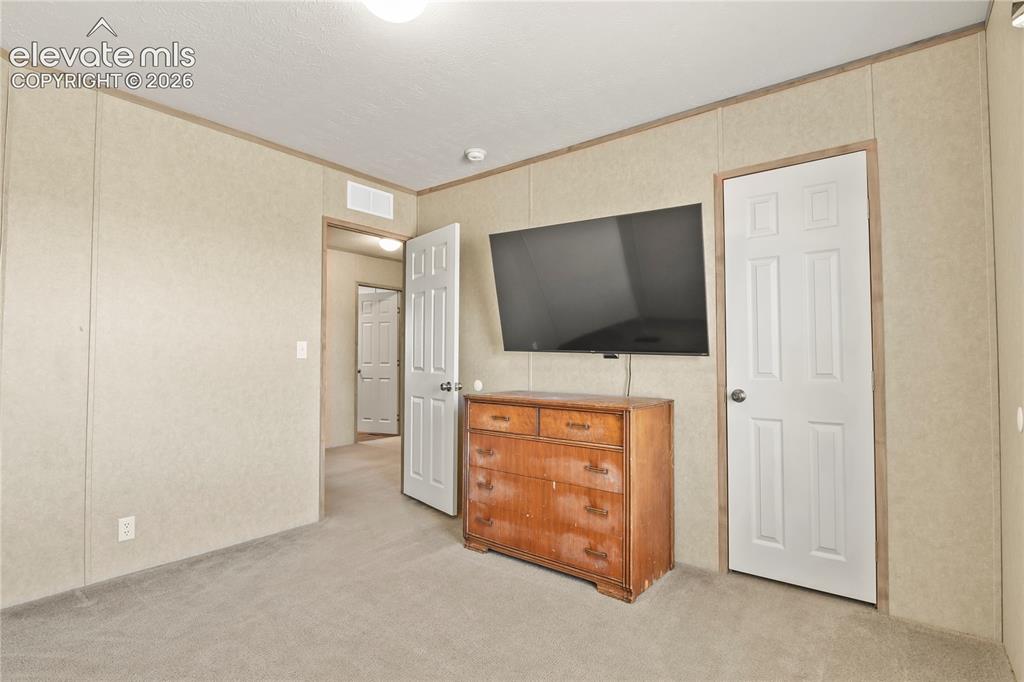 22280 Jones Road Peyton, CO 80831 - Photo 20 of 47 a living room with furniture and a flat screen tv