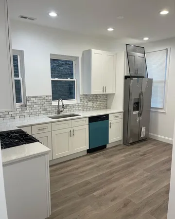 a kitchen with stainless steel appliances a refrigerator sink and cabinets