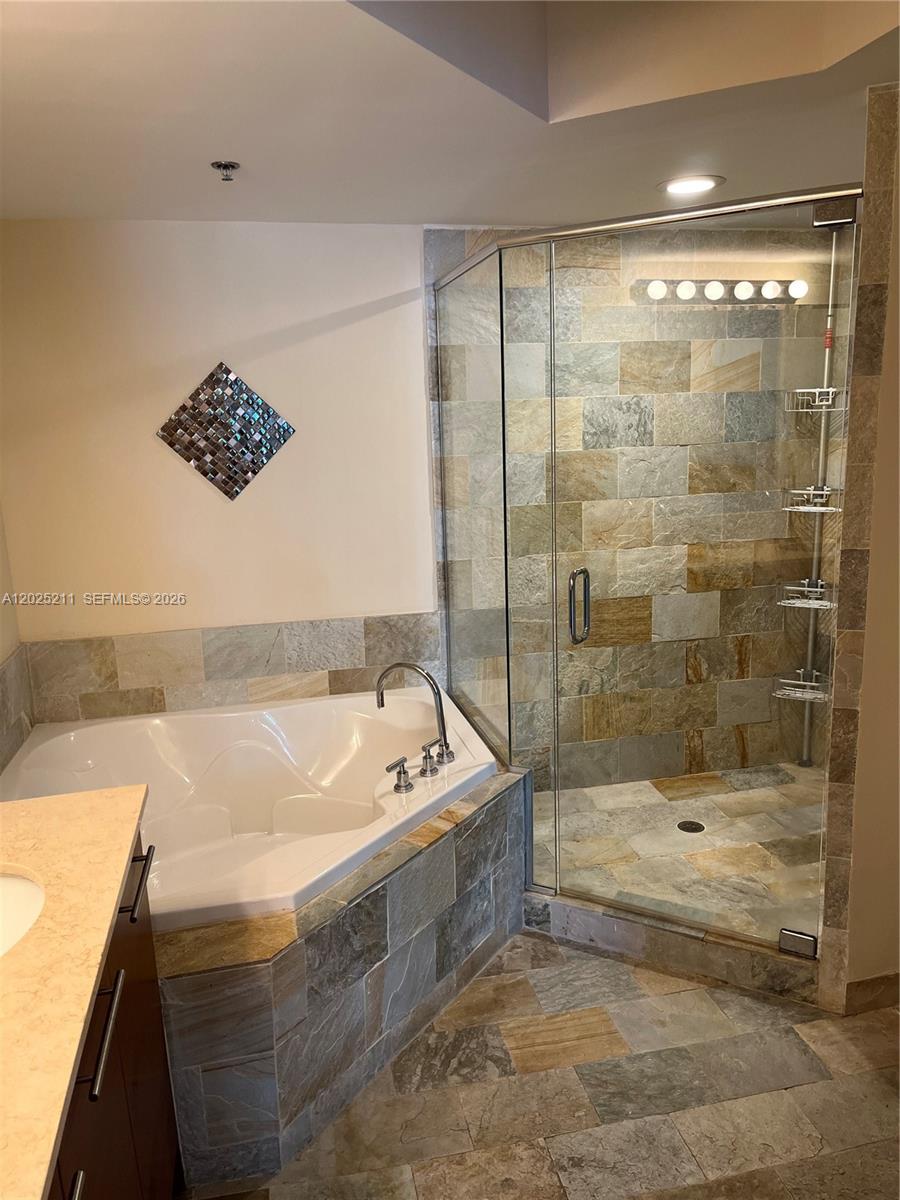 2681 North Flamingo Road, Unit 303S Sunrise, FL 33323 - Photo 11 of 18 a bathroom with a tub a sink and a shower