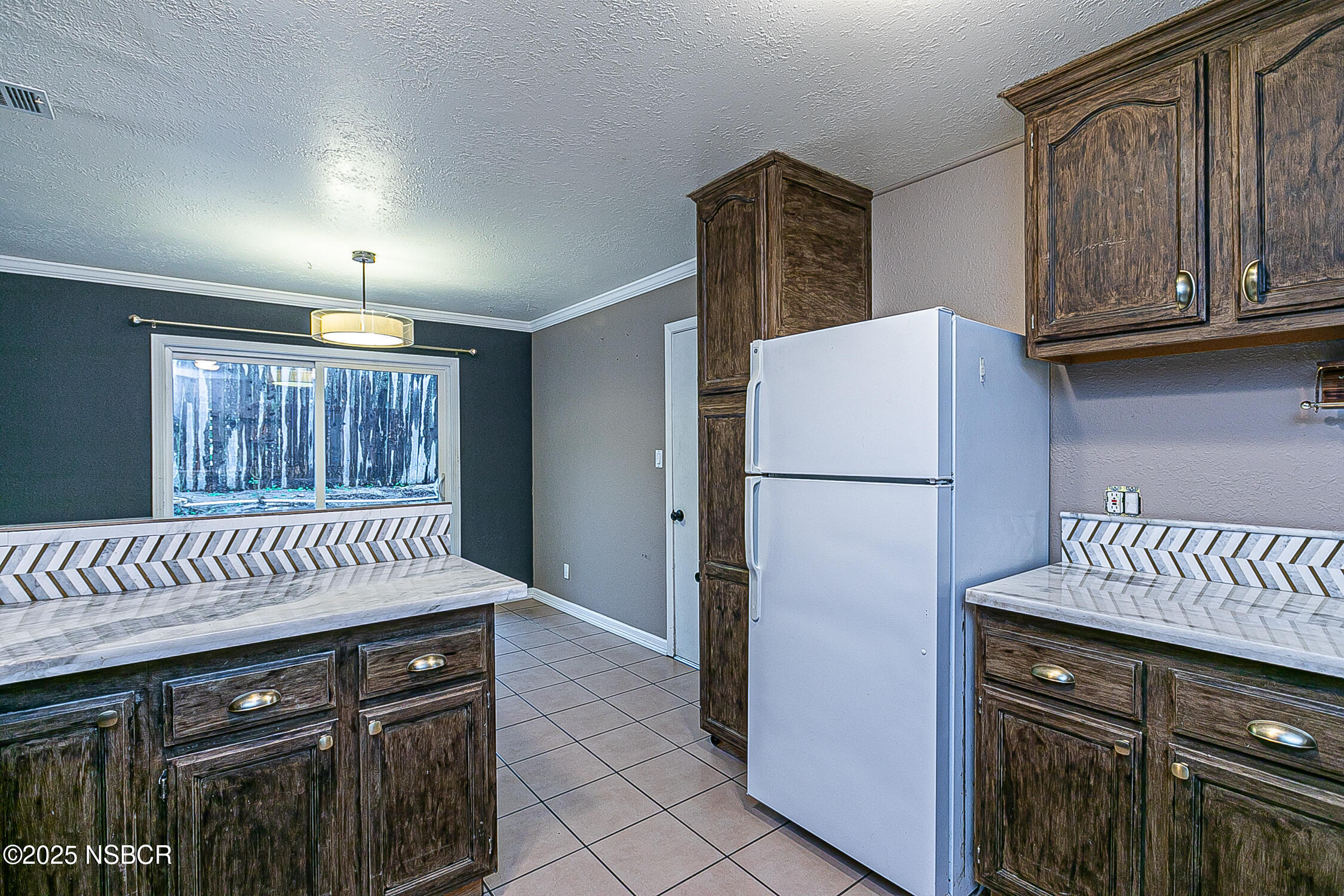 533 Sunbeam Road Lompoc, CA 93436 - Photo 11 of 27 a kitchen with granite countertop a refrigerator a stove a sink and dishwasher with wooden cabinets