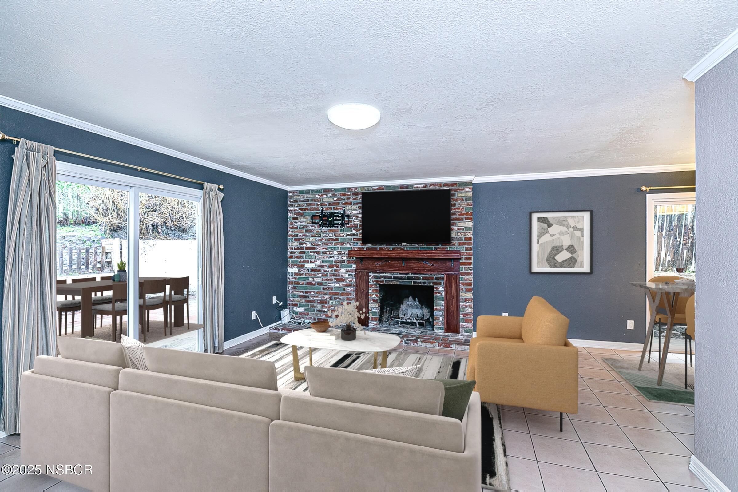 533 Sunbeam Road Lompoc, CA 93436 - Photo 2 of 27 a living room with furniture a flat screen tv and a fireplace
