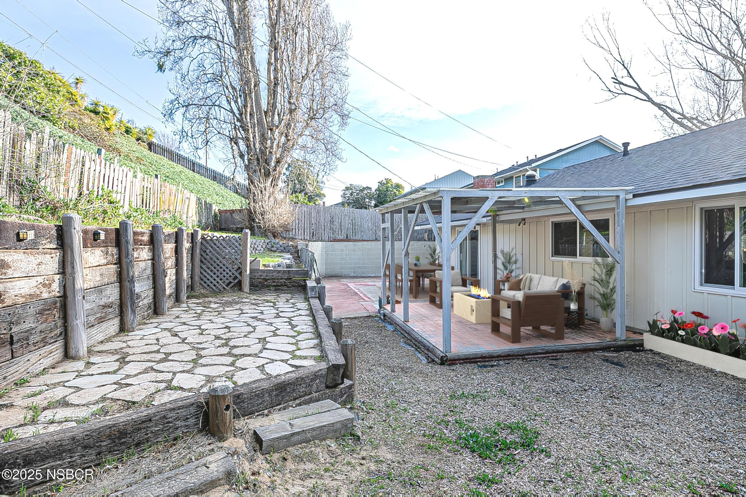 533 Sunbeam Road Lompoc, CA 93436 - Photo 7 of 27 a view of a patio with table and chairs potted plants and large tree