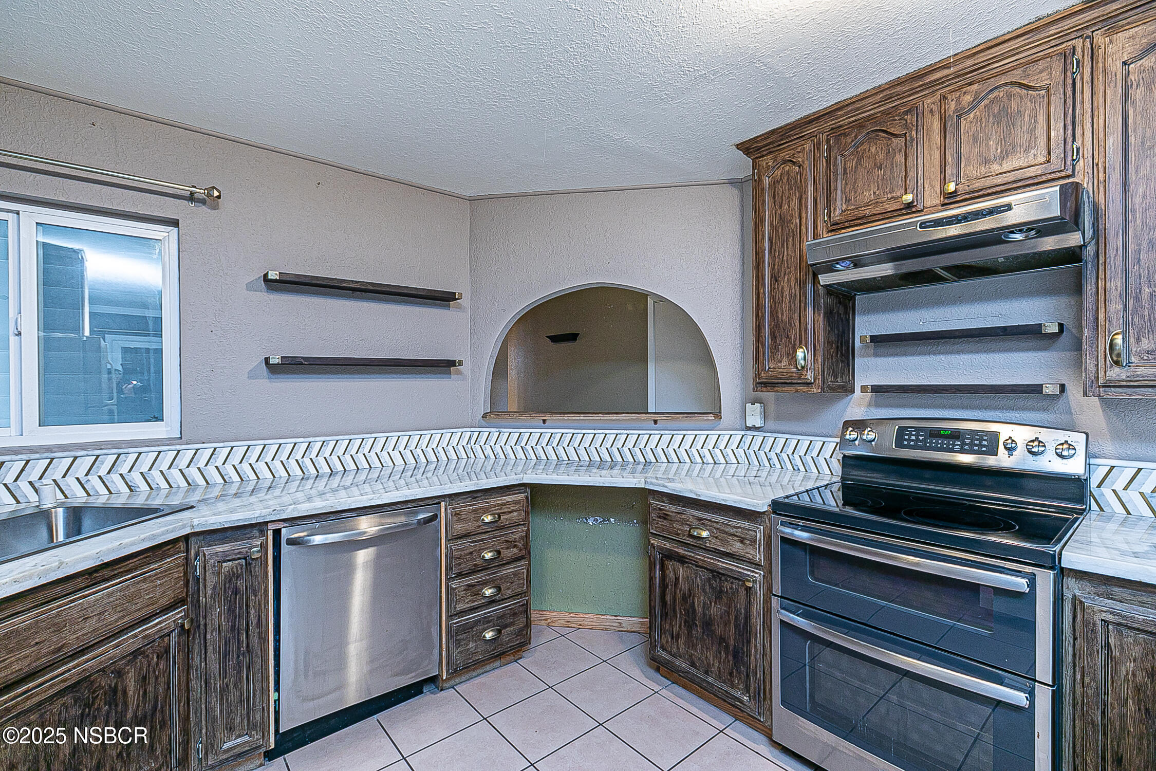 533 Sunbeam Road Lompoc, CA 93436 - Photo 8 of 27 a kitchen with granite countertop a stove a washer and dryer