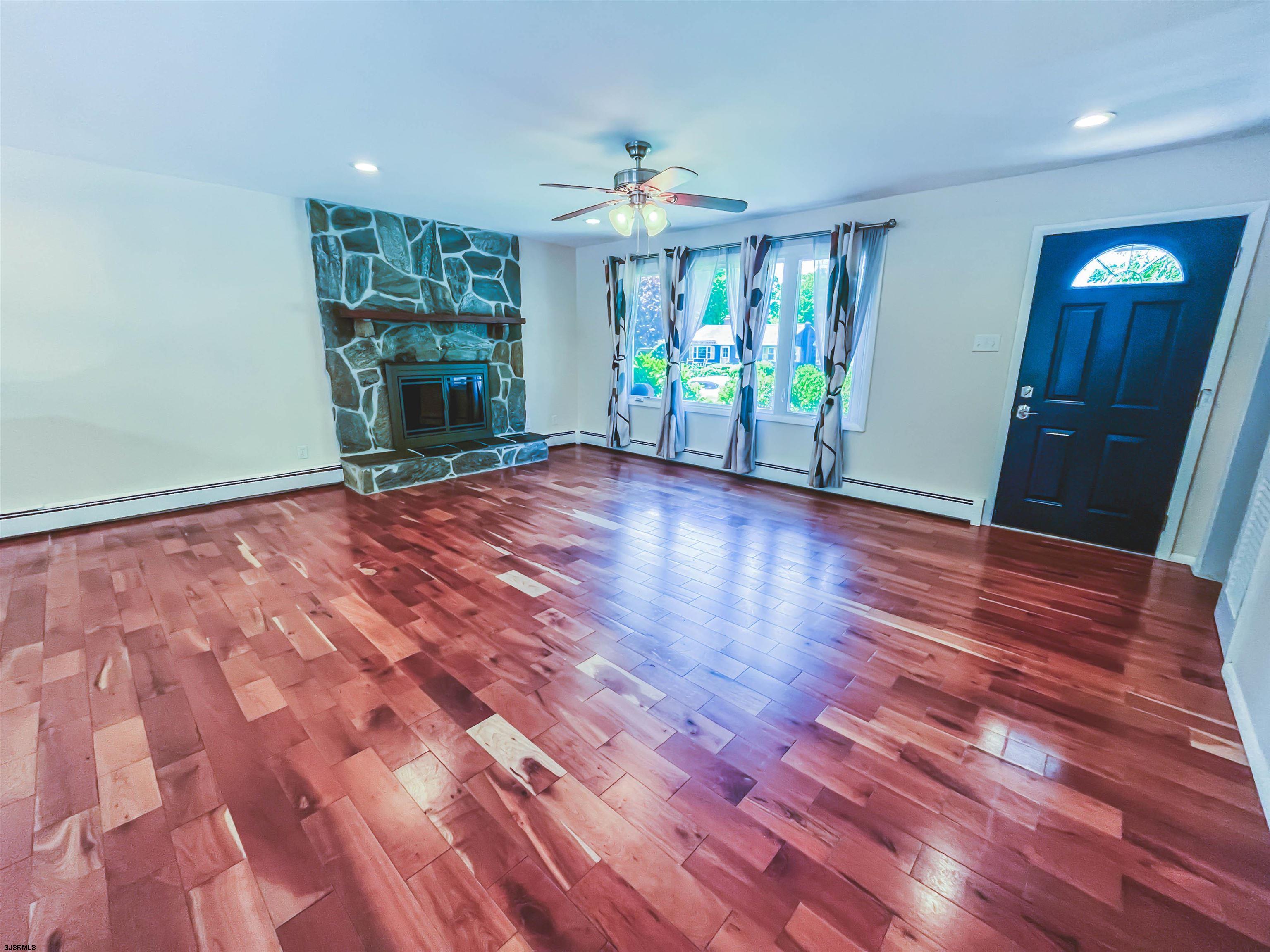 518 Delaware Avenue Absecon, NJ 08201 - Photo 6 of 38 a view of an empty room with a window and wooden floor