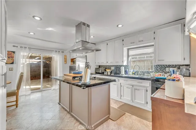 a kitchen with granite countertop a refrigerator oven and stove top oven