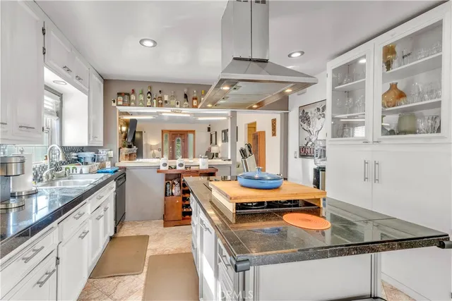 a kitchen with stainless steel appliances granite countertop a stove and a refrigerator