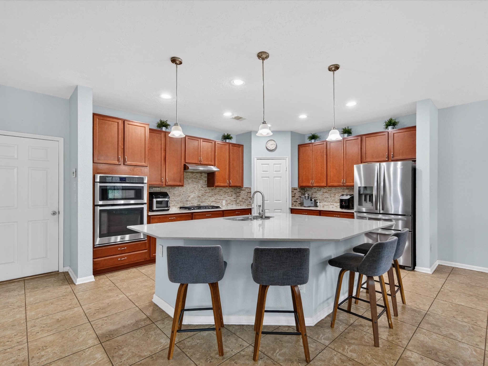 20703 Fawn Timber Trail Humble, TX 77346 - Photo 8 of 42 a kitchen with stainless steel appliances a refrigerator and a stove top oven