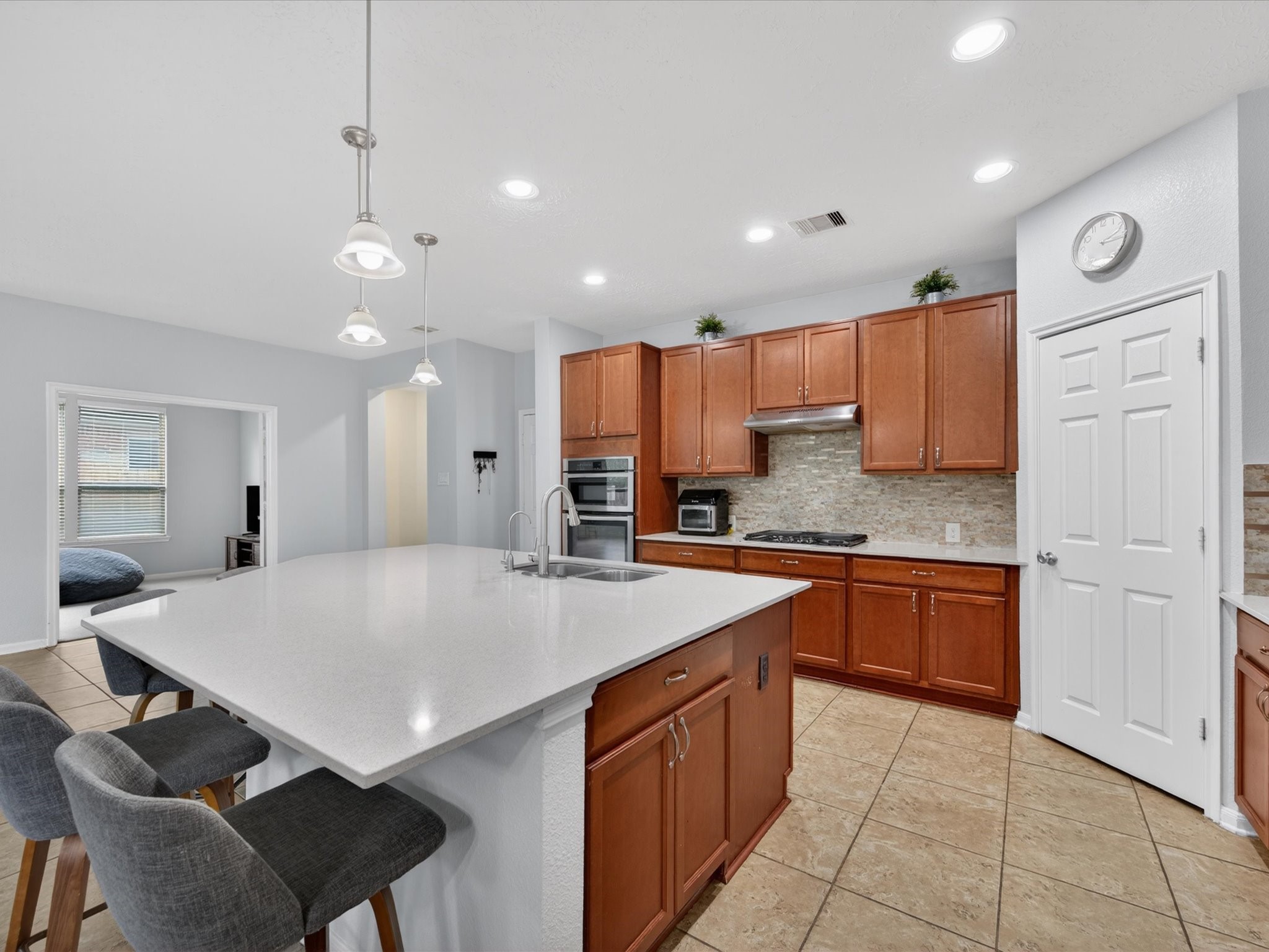 20703 Fawn Timber Trail Humble, TX 77346 - Photo 9 of 42 a large kitchen with kitchen island a stove a sink a refrigerator and a granite counter tops