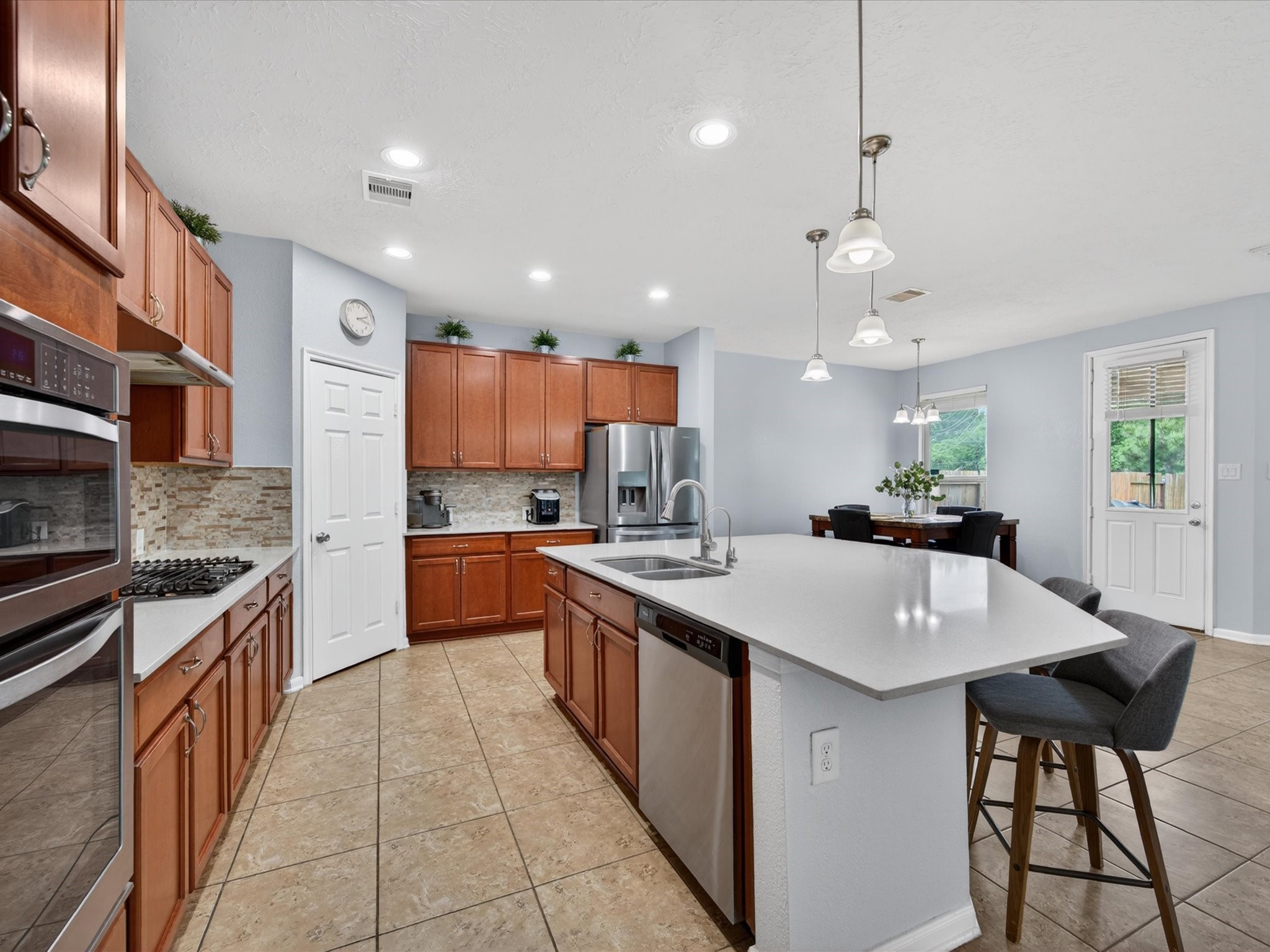 20703 Fawn Timber Trail Humble, TX 77346 - Photo 10 of 42 a large kitchen with stainless steel appliances lots of counter space and windows