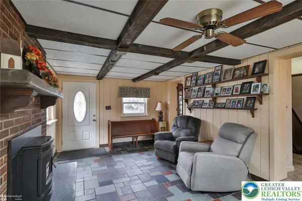 a living room with furniture a window and a fireplace