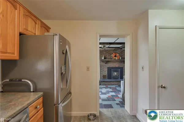 a kitchen with stainless steel appliances granite countertop a refrigerator and a sink