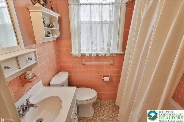 a white toilet sitting next to a bathroom sink