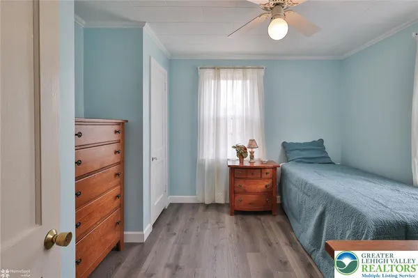 a room with a bed and a dresser