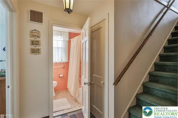 a view of a bathroom with wooden floor and glass door
